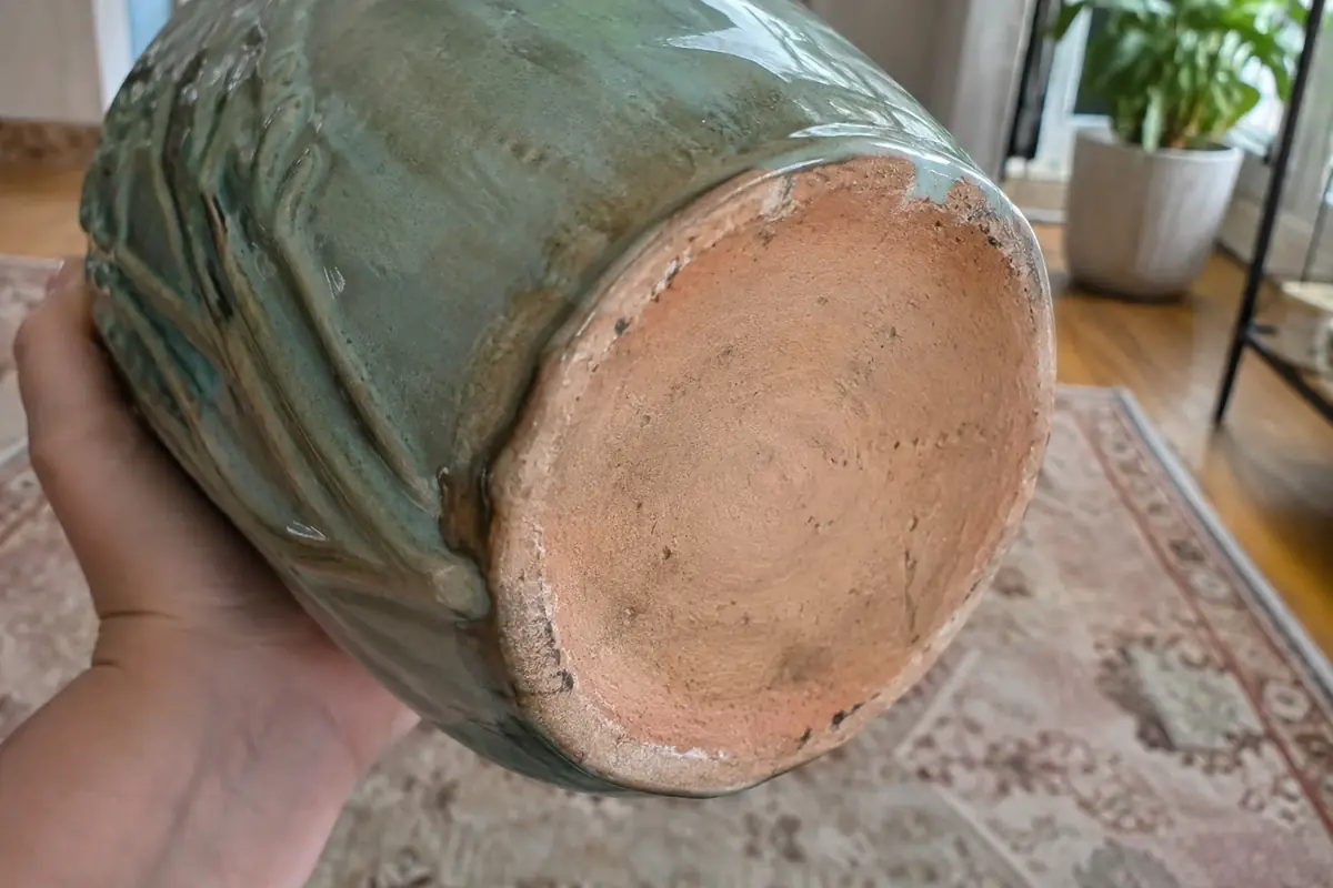 Underside of a McCoy vase showing unglazed tan clay footring and pooled glaze